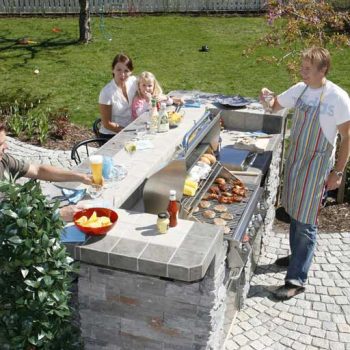 Family enjoying their custom outdoor kitchen setup from The Recreational Warehouse Southwest Florida's Leading Warehouse for Spas, Hot Tubs, Pool Heaters, Pool Supplies, Outdoor Kitchens and more!