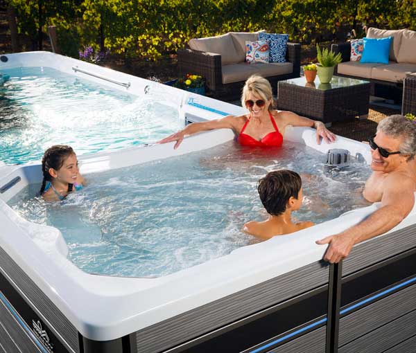 Family relaxing in E200 Endless Pool | Endless Pools Fitness Systems available at the Recreational Warehouse Southwest Florida (Naples, Fort Myers and Port Charlotte Locations) Pool Warehouse