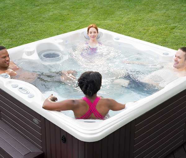 Group of friends enjoying Vanto Hot Tub Caldera Spa | Caldera Spas available at the Recreational Warehouse Southwest Florida (Naples, Fort Myers and Port Charlotte Locations) Pool Warehouse