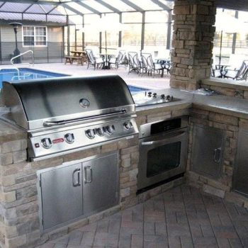 Pool side custom outdoor kitchen setup from The Recreational Warehouse Southwest Florida's Leading Warehouse for Spas, Hot Tubs, Pool Heaters, Pool Supplies, Outdoor Kitchens and more!