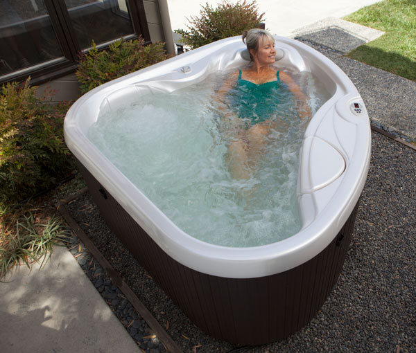 Woman relaxing in TX Hot Tub Spa | Hot Springs Spas available at the Recreational Warehouse Southwest Florida (Naples, Fort Myers and Port Charlotte Locations) Pool Warehouse