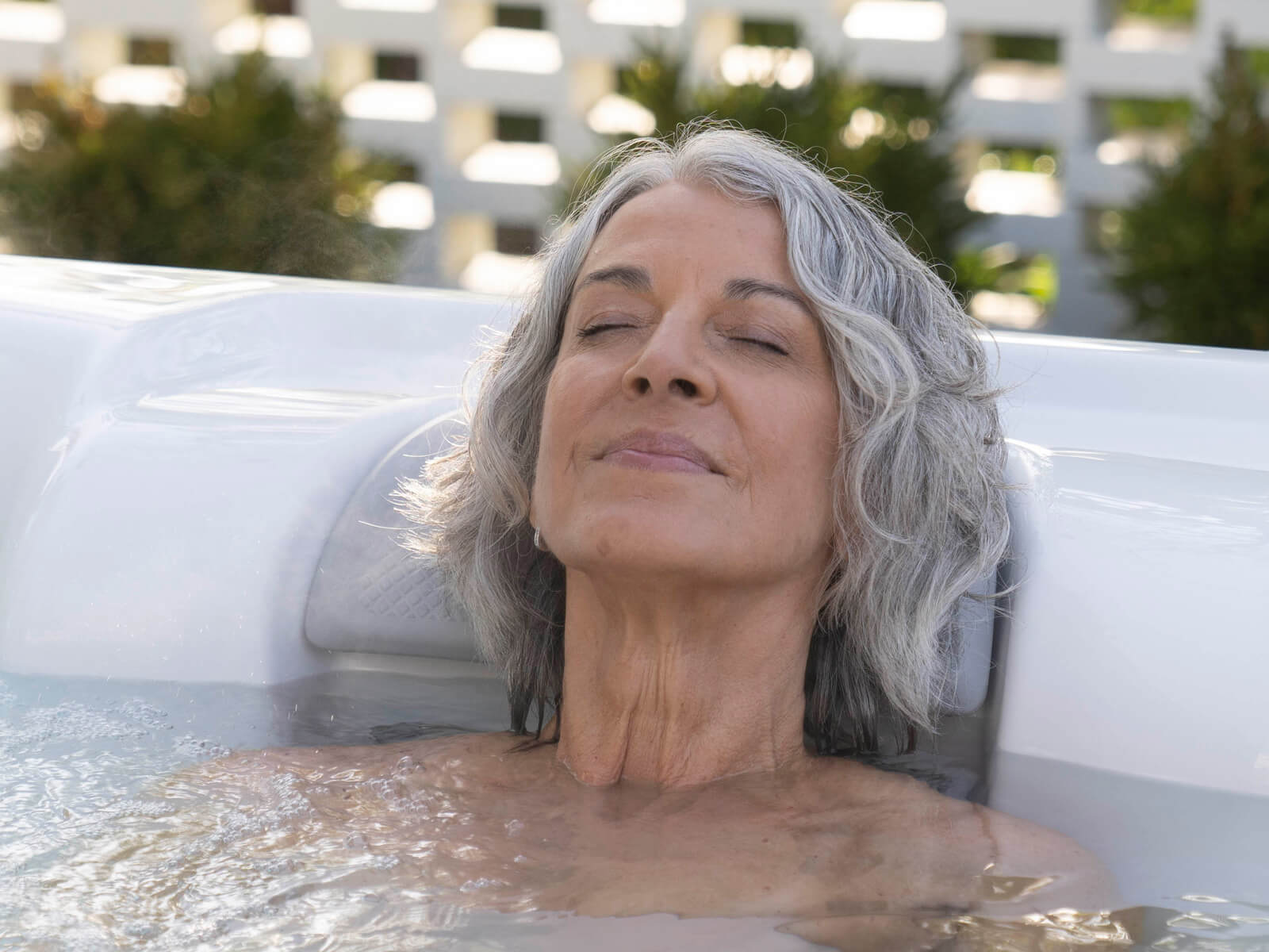 Woman relaxing in Jetsetter Hot Tub Spa | Hot Springs Spas available at the Recreational Warehouse Southwest Florida (Naples, Fort Myers and Port Charlotte Locations) Pool Warehouse